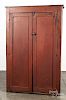 Painted pine cupboard, 19th c., retaining an old red surface, 63 1/2'' h., 39 1/2'' w.