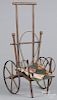 G. A. Heimer paper litho child's push toy, 24'' l., together with a childs bamboo doll stroller, earl
