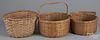 Three split oak baskets, largest - 13'' h., 14'' w.