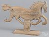 Carved pine running horse with traces of white paint, 12 3/4'' h., 18 3/4'' w.