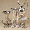 Seven pieces of weighted silver, to include two golfing trophies, a compote, and three candlesticks