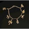 Gold Bracelet with Seven Western Themed Charms, 10-14K