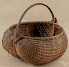 Splint oak god's-eye buttocks basket, late 19th c., 14 1/2'' h., 15'' w.