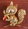 Wire constructed 18K yellow gold squirrel brooch with coral and a ruby eye, 8.3 dwt.