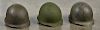 Three WW II helmets, one missing liner