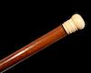 A 19TH C. CHERRY WOOD AND IVORY WALKING STICK