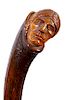 302. Native American Folk-Art Cane – Ca. 1900 – A carved one-piece bark shaft which has a detailed carving of a Native Am