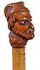 335. Folk-Art Man Cane – Ca. 1890 – A carved folk-art man with two-colored glass eyes, stepped bamboo shaft, and a horn f