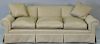 Custom tan upholstered sofa with rolled arms and three down filled cushions. lg. 92in. very clean condition