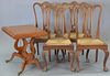 Five piece lot including Contemporary table with harp Duncan Phyfe style base and four Chippendale style rush seat chairs.