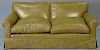 Tan leather upholstered loveseat. lg. 72in.