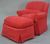 Henry Chan Furniture Co. New York, red upholstered swivel club chair with footstool and down filled cushions.