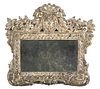 A Continental Stamped Silvered Metal Mirror Height 15 1/2 x width 15 1/2 inches.