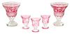 A Collection of Cranberry Cut-to-Clear Glass Height of vase 8 1/2 inches.