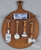 Pine breadboard mounted with Meissen style blue onion kitchen utensils, 23'' x 18 1/2''.