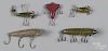 Five miscellaneous wood fishing lures, to include a Heddon 1600 deep diver wiggler, Shakespeare unde