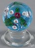 Charles Kaziun Jr., red coiled rose pedestal paperweight, with three millefiori canes on a blue grou