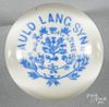 Light blue frit paperweight on a white ground with a group of thistles, inscribed Auld Lang Syne,