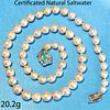 IMPORTANT CERTIFICATED NATURAL SALTWATER PEARL NECKLACE WITH AN EMERALD AND DIAMOND CLASP