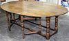 A Large Oak Gate-Leg Dining Table Height 28 1/2 x width 91 x depth 21 1/2 inches.