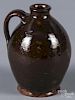 Small New England redware jug, 19th c., with orang