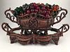 Glass fruit basket in a bronze two handled basket.