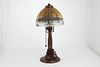 First quarter 20 th Century Handel boudoir table lamp. <BR>The 7 inch glass shade