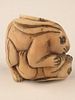 A carved Netsuke figure of two rabitts playing.