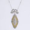 Antique style Approx. 1.0 Carat Diamond and 14 Karat Yellow and White Gold Pendant Necklace.