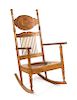 A Carved Oak Rocking Chair Height 42 inches.