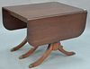Mahogany drop leaf dining table with three leaves.