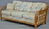 Four piece lot to include a pair of rattan sofas and two glass top tables. sofas: lg. 73 1/2in.