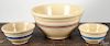 Four yellowware mixing bowls, largest - 8 1/4'' h., 15 3/4'' dia.