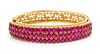 An 18 Karat Yellow Gold and Ruby Bangle Bracelet, 19.00 dwts.