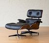 CHARLES AND RAY EAMES / HERMAN MILLER LEATHER UPHOLSTERED ROSEWOOD LOUNGE CHAIR AND OTTOMAN