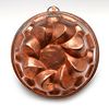 AN ANTIQUE HAMMERED COPPER FOOD MOLD
