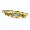 Vintage 14 Karat Yellow Gold Bangle Bracelet set with an Oval Cut Opal and Seed pearls.