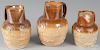 Three salt glaze stoneware pitchers