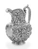 * An American Silver Water Pitcher, J.E. Caldwell, Philadelphia, PA, the baluster form body having repousse floral and foliat