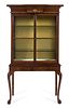 * A Queen Anne Style Parcel Gilt Mahogany Vitrine Cabinet Height 70 x width 37 1/4 x depth 14 3/4 inches.