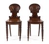 A Pair of Regency Mahogany Hall Chairs Height 34 1/8 inches.