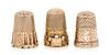 * Three Yellow Gold Thimbles, , each having a knurled top and body, one example with a trefoil decorated band to the base, on