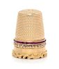 * A Continental 18-Karat Yellow Gold and Gem Thimble, , the knurled top and body above a double band inset with rubies and di