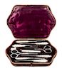 * An English Silver and Mother-of-Pearl Sewing Kit, , the leather case opening to a fitted interior with various sewing tools