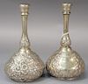 Pair of sterling silver cologne bottle with repousse bodies, monogrammed (dents). 
ht. 7 3/4in. 
11.8 troy ounces
