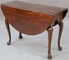 Mahogany Queen Anne drop leaf table with oval drop leaves set on cabriole legs ending in trifid style foot.  ht. 28 3/4in., t
