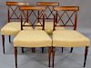 Set of four Sheraton mahogany side chairs, each with satin wood panel over double X back, fully upholstered seats set on turn