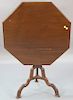English carved mahogany tilt top tea table, 19th century, the octagonal shaped tip top on standard with tripod base. 
ht. 26i