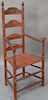 Ladder back great chair, four slat with mushroom top hand rests and rush seat on sausage turned legs (legs ended out, one sla