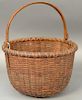 Nantucket basket with swing handle signed on handle L.W. Parker (3-4 minor imperfections). 
ht. 7in., dia. 10 1/2in.